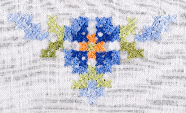 Blue flower tringle motiv hand embroidery on white linen tablecloth