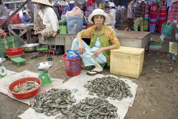 Vietnamese woman sells  prawns at a market of Mui Ne, Vietnam.