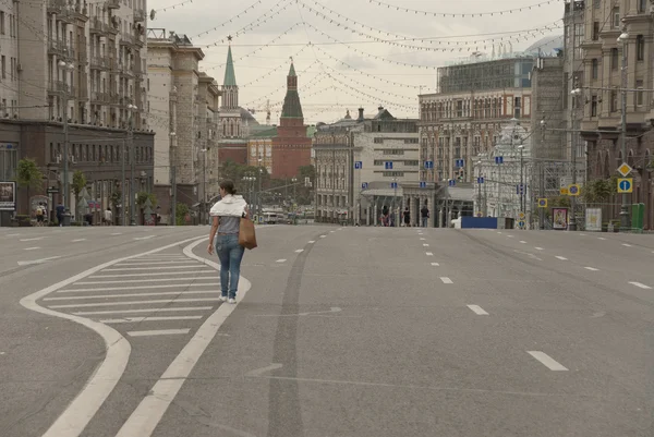 Woman walks down empty Tverskaya street during City Festival in Moscow, Russia.