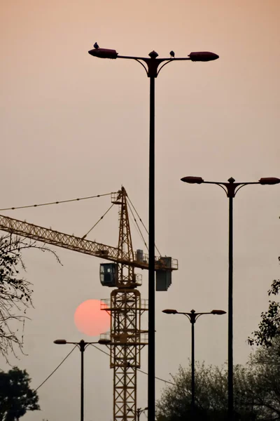 Sunset with lights and construction, New Delhi, India.