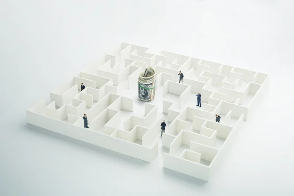 The uncertainty of money and business. Dollar banknotes hidden inside a maze