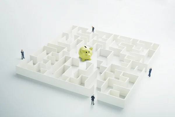 The uncertainty of money and business. Piggy bank hidden inside a maze