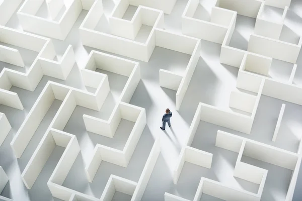 Business challenge. A businessman navigating through a maze