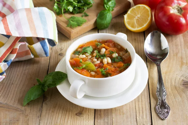 Traditional dish of Greek cuisine. White beans soup with tomatoes and fresh herbs. Fasolada - national food of the Greeks