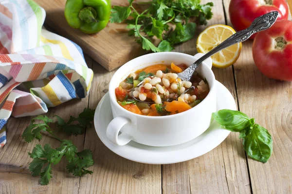 Traditional dish of Greek cuisine. White beans soup with tomatoes and fresh herbs. Fasolada - national food of the Greeks