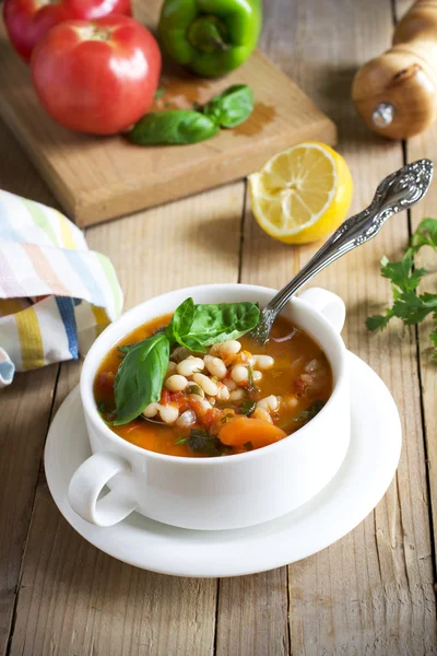 Traditional dish of Greek cuisine. White beans soup with tomatoes and fresh herbs. Fasolada - national food of the Greeks