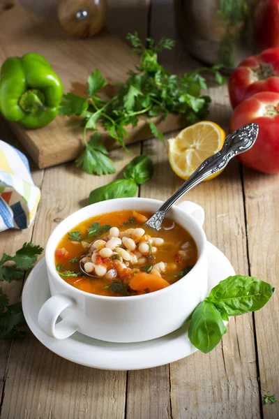 Traditional dish of Greek cuisine. White beans soup with tomatoes and fresh herbs. Fasolada - national food of the Greeks