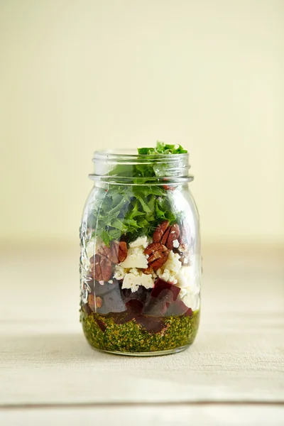 Jar of rocket leaves, couscous and red beet
