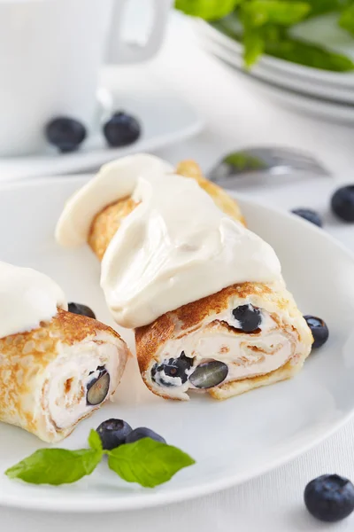 Sweet crepes with cream and blackberries