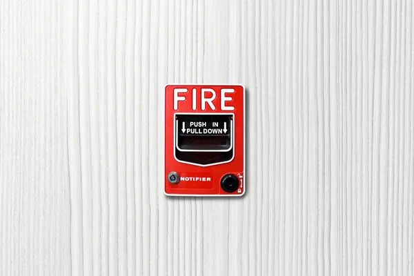 Fire alarm switch on white wood background