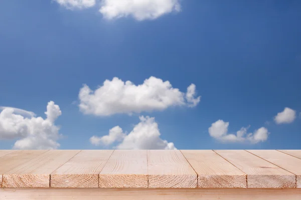 Brown wood table top on bokeh abstract blue sky background - can