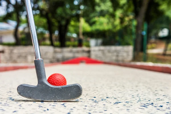 Closeup of red mini golf ball.