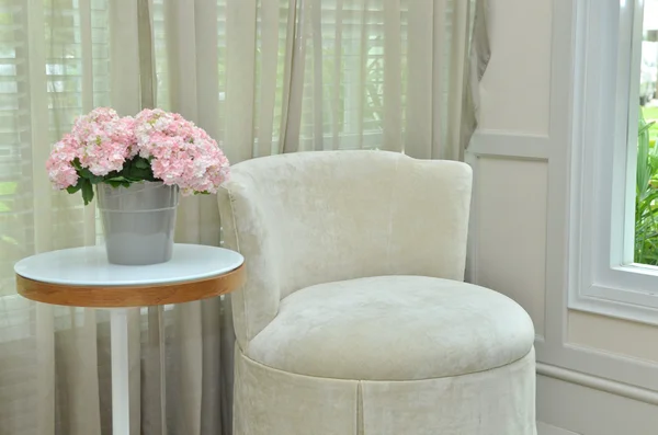 Interior design of modern room with chair, table and bouquet flower