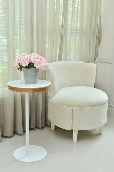 Interior design of modern room with chair, table and bouquet flower