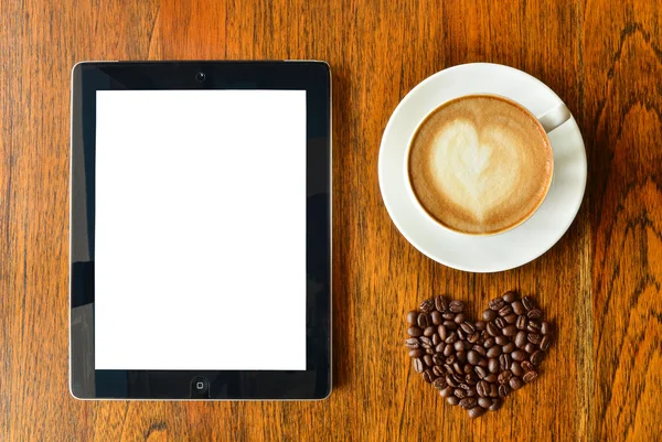 Digital tablet pc and a cup of coffee with heart shape