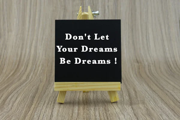 Art board, wooden easel, front view with word Don\'t Let Your Dreams Be Dreams !