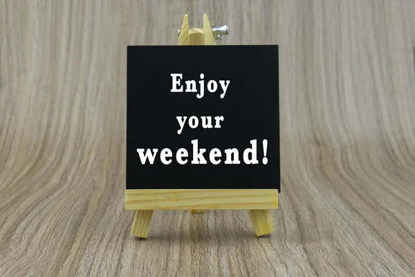 Art board, wooden easel, front view with word Inspiration quote : Enjoy your weekend