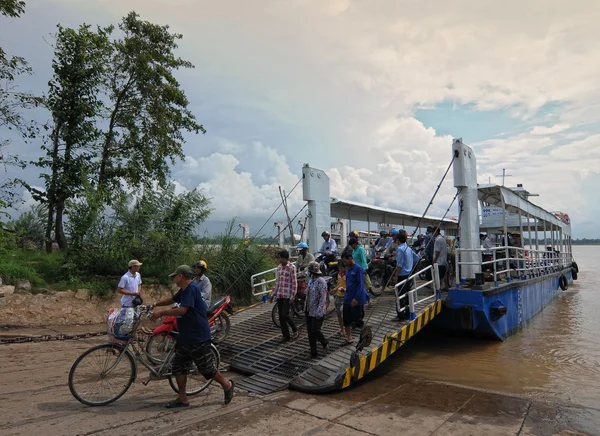 Crowd of people cross the river by ferry boat