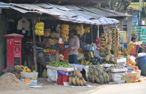 Sellers in street shop sell fresh fruits in Sri Lanka