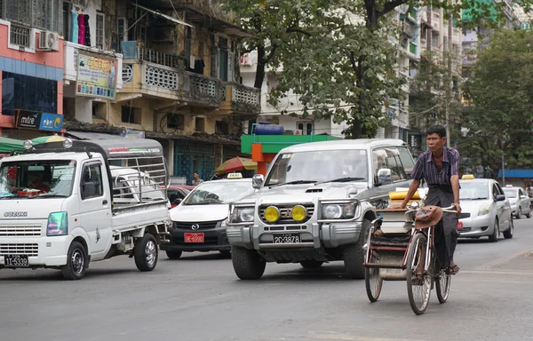 People, cars and bikes on the streets in Mandalay