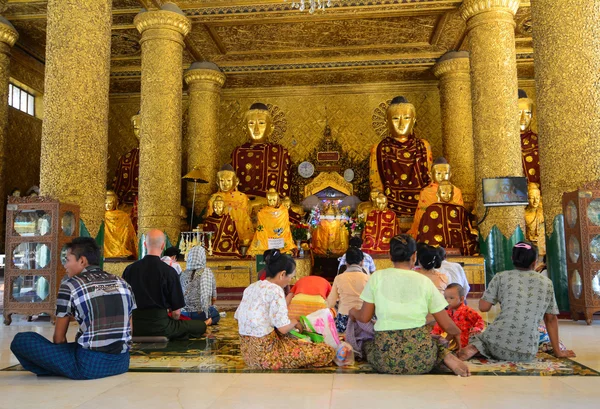 Burmese people pray at Shwedagon Pagoda in Yangon