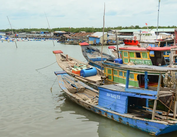 Fishing boats have a rest at the city river port in Vietnam