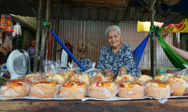 Elderly woman selling rice cakes