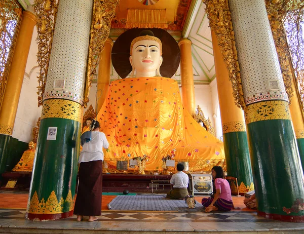 Burmese people pray at Shwedagon Pagoda in Yangon