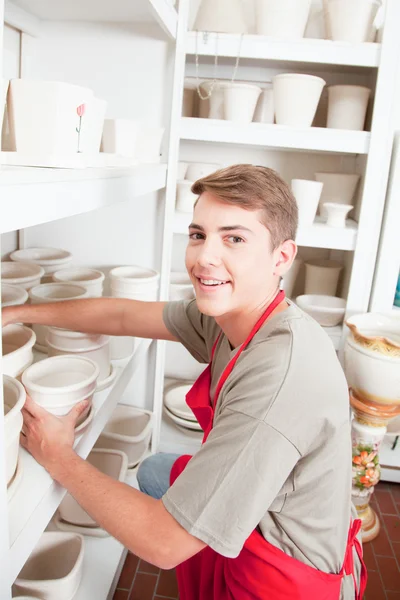 Man looking at the camera in a ceramics shop