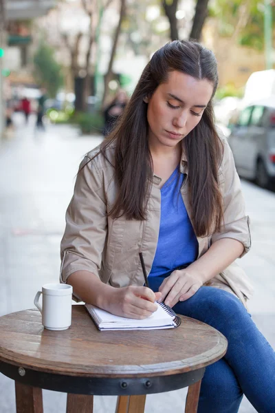 Woman writing on the street