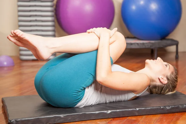 Young woman stretching in yoga