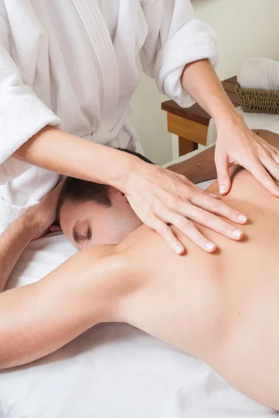 Man back laid receiving massage