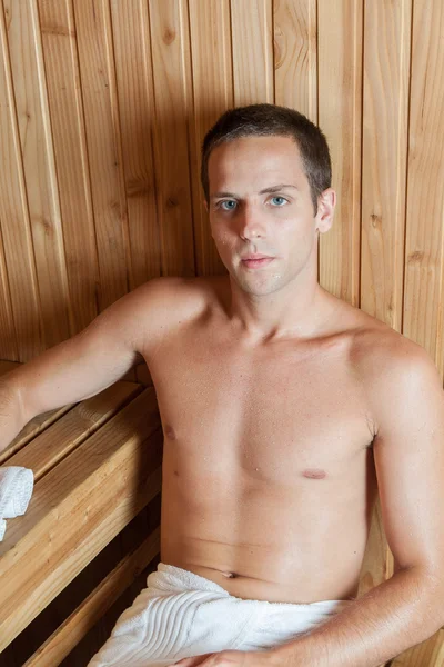 Serious man resting in the sauna