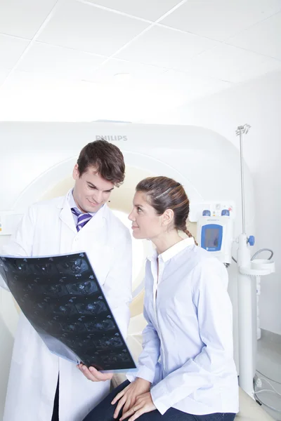 Doctor and patient looking at tomography