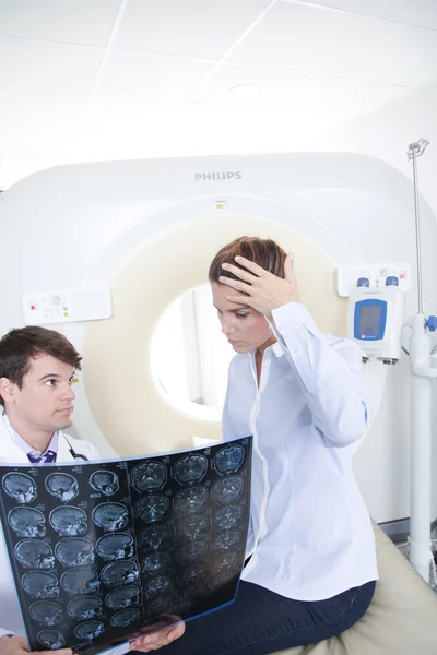 Doctor giving tomography to patient