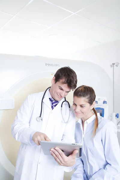 Doctor and patient near tomography scanner