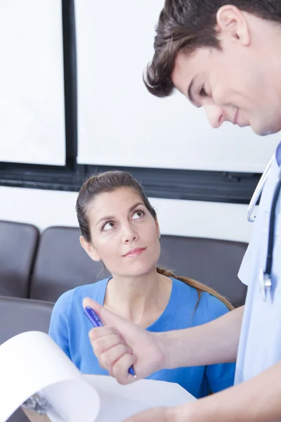 Male nurse talking with woman