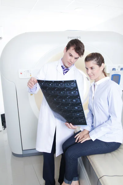 Doctor and patient looking at tomography