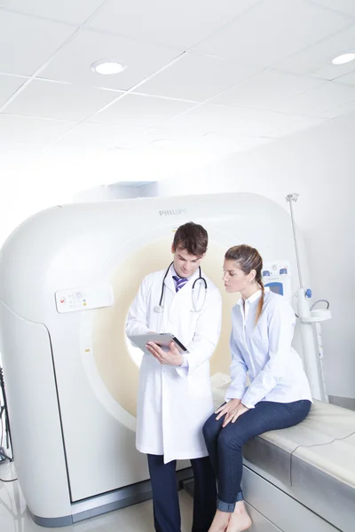 Doctor and patient near tomography scanner