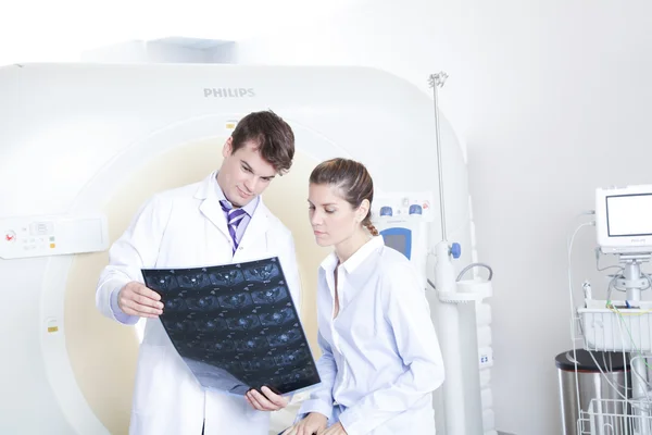 Doctor and patient looking at tomography