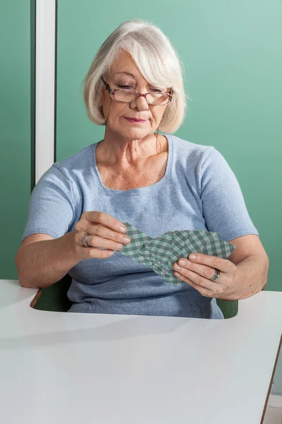Elder Woman playing cards