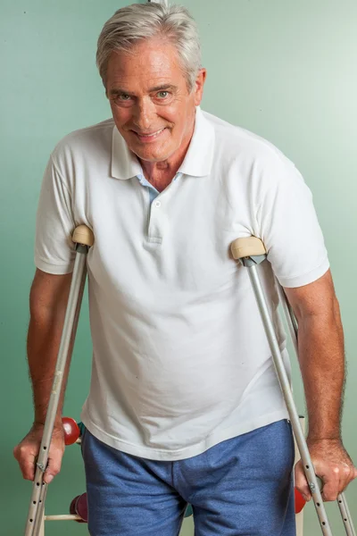 Elder man using a crutches