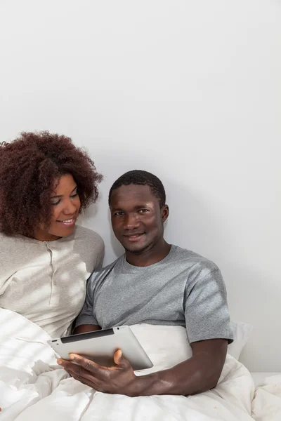 African couple using digital tablet