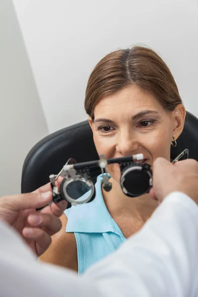 Ophthalmologist putting lenses