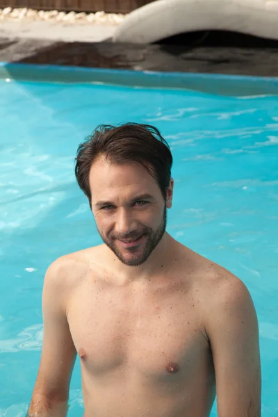 Man posing in swimming  pool