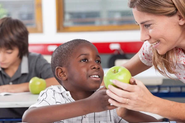 Boy giving to his teacher  apple