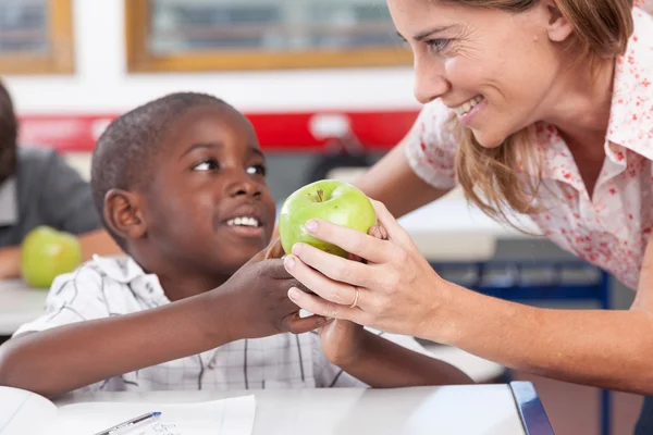 Boy giving to his teacher  apple