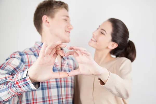 Couple in love making heart sign