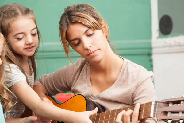 Teacher playing guitar
