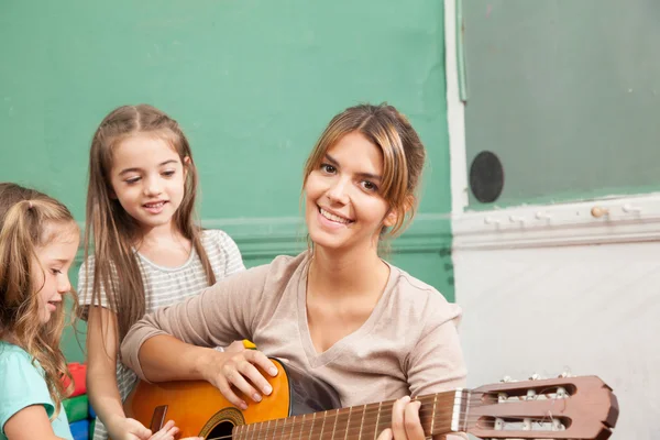 Teacher playing guitar